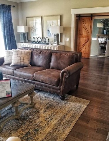 Residential area rug and wood flooring in Franklin, KY from Shop at Home Carpets